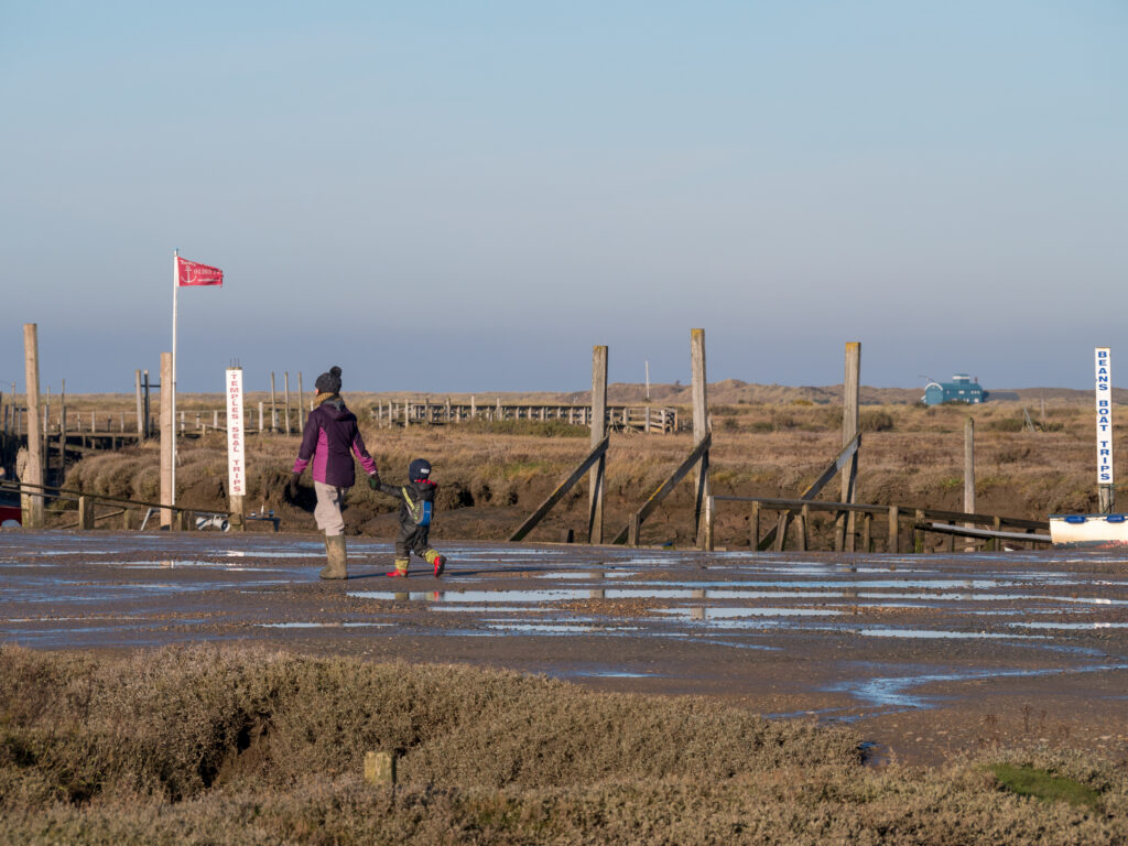 Family walking near the quay at Morston Quay, Blakeney National Nature Reserve, Norfolk